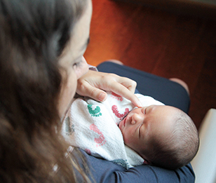 A woman holding a baby in her arms.