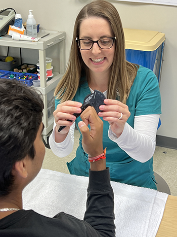 Katelyn Ruggiero, Occupational Therapist and Certified Hand Therapist at St. Joseph’s Hospital, conducting hand therapy on a patient.