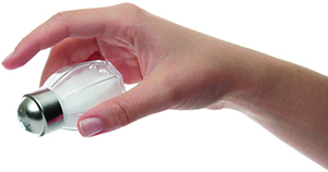 The image shows a hand holding a salt shaker, tilted as if about to sprinkle salt.