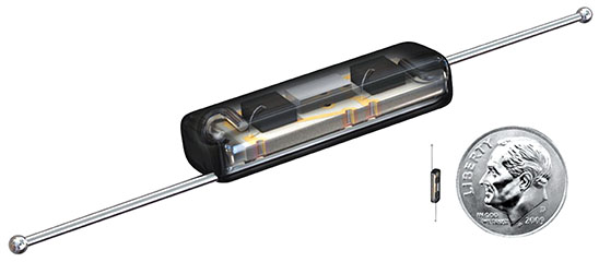 The image shows a small electronic component with a transparent casing, revealing internal circuitry, alongside a U.S. dime for scale comparison.