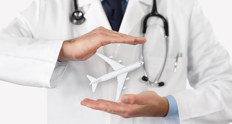 A physician holding a model airplane.