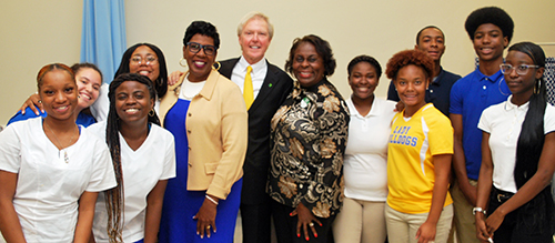 St. Joseph's/Candler President & CEO Paul P. Hinchey stand with a group of Beach High School students