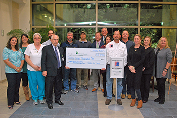 Members of the group Fishin' For Jamie donate a check for $27,000 to the Nancy N. and J.C. Lewis Cancer & Research Pavilion for skin cancer research and treatment