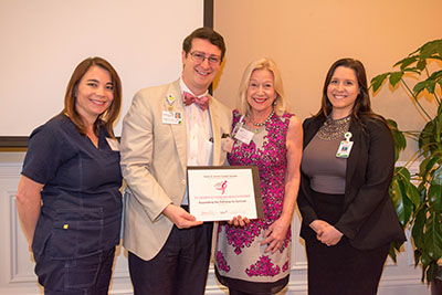 St. Joseph's/Candler co-workers Amanda Taylor, William James, Vernice Rackett and Adeline Langenburg accept the award and grant from Susan G. Komen Coastal Georgia