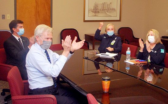 A team of people engaged in a discussion at the conference table.
