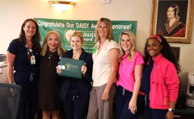 Our latest DAISY Award winner, Carly Clark, pictured in the center surrounded by fellow co-workers