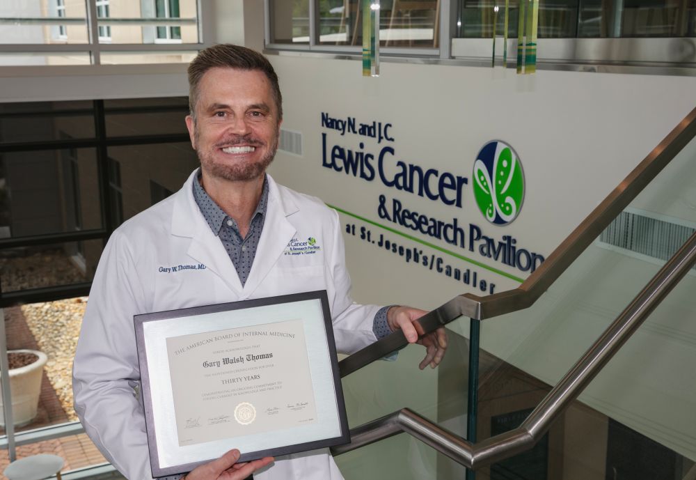 Dr. Gary Thomas with his award for being recognized for 30 plus years of service in oncology